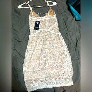 Brand new white dress. Under is tan almost a skin shade really pretty